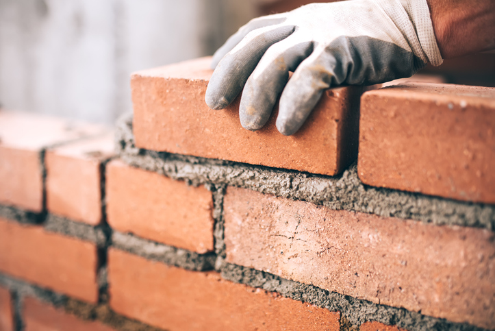 hand laying brick foundation